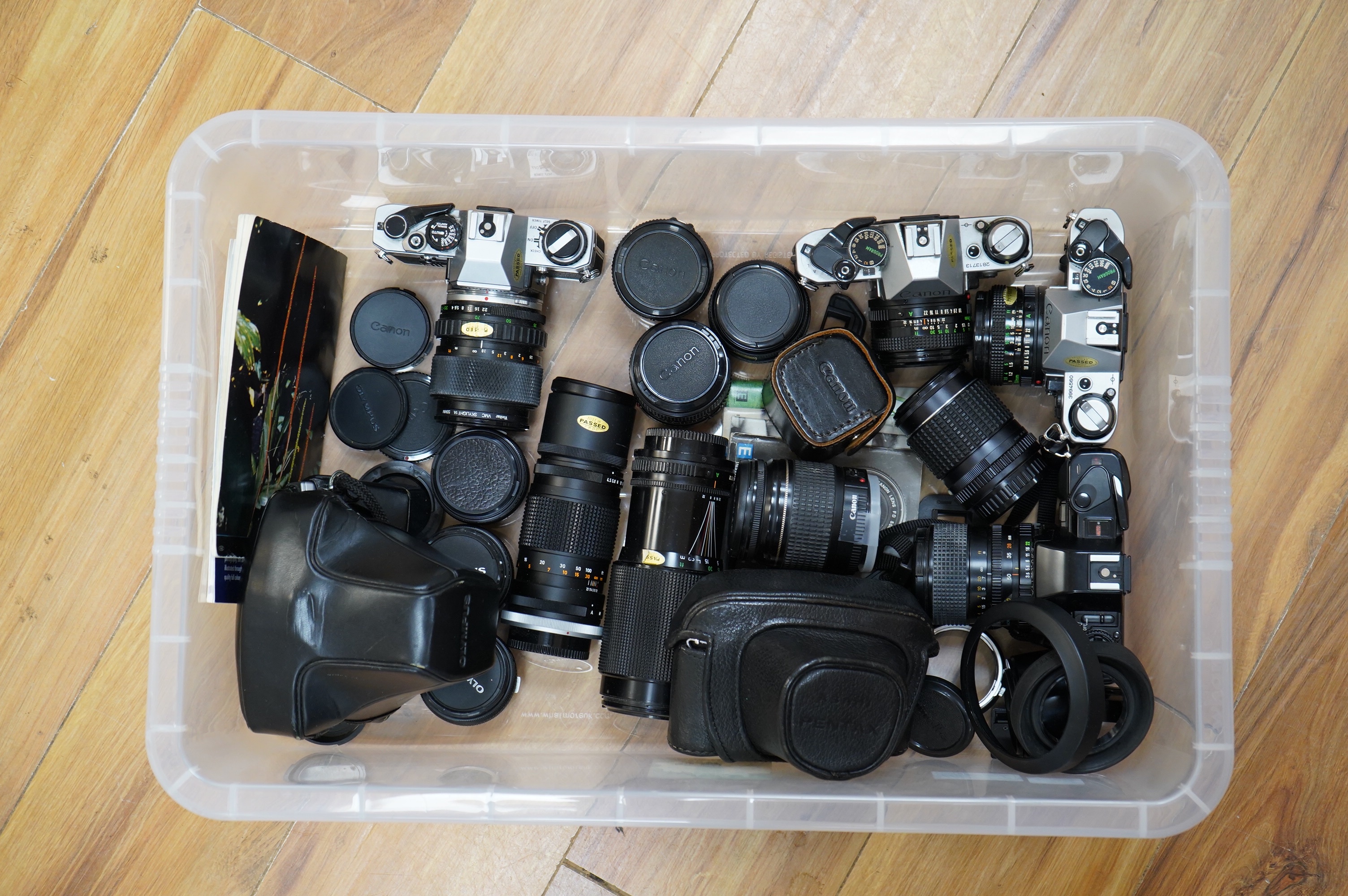 A quantity of various cameras and lenses to include Olympus, Minolta, Pentax and Canon. Condition - varies